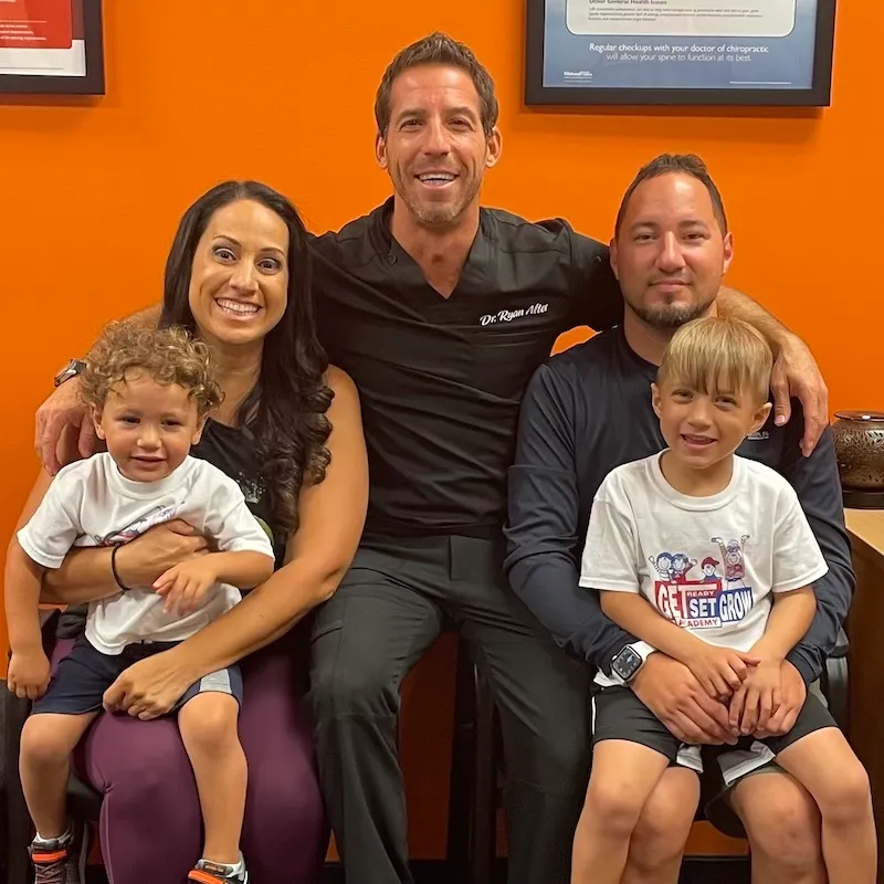 Dr Ryan with smiling family with two young children