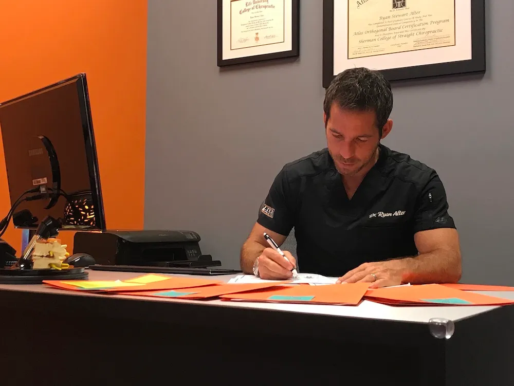 Dr. Ryan Alter doing documentations for patient