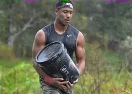 Stephan Simmons carrying a bucket during a Spartan race