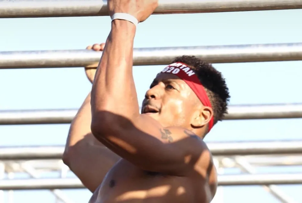 Stephan Simmons on the monkey bars at a Spartan race