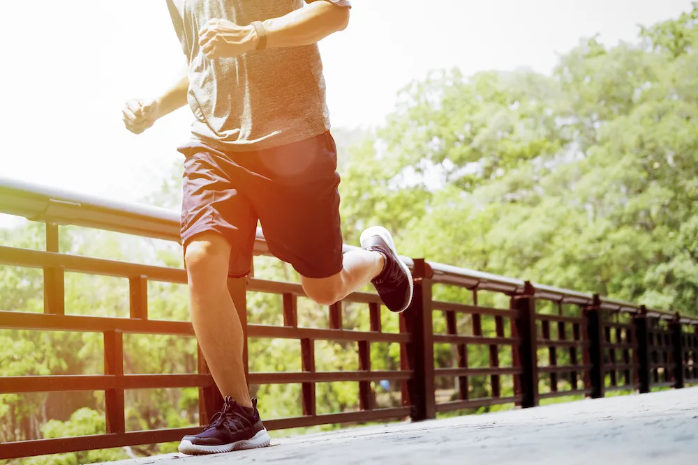 runner jogging across a bridge